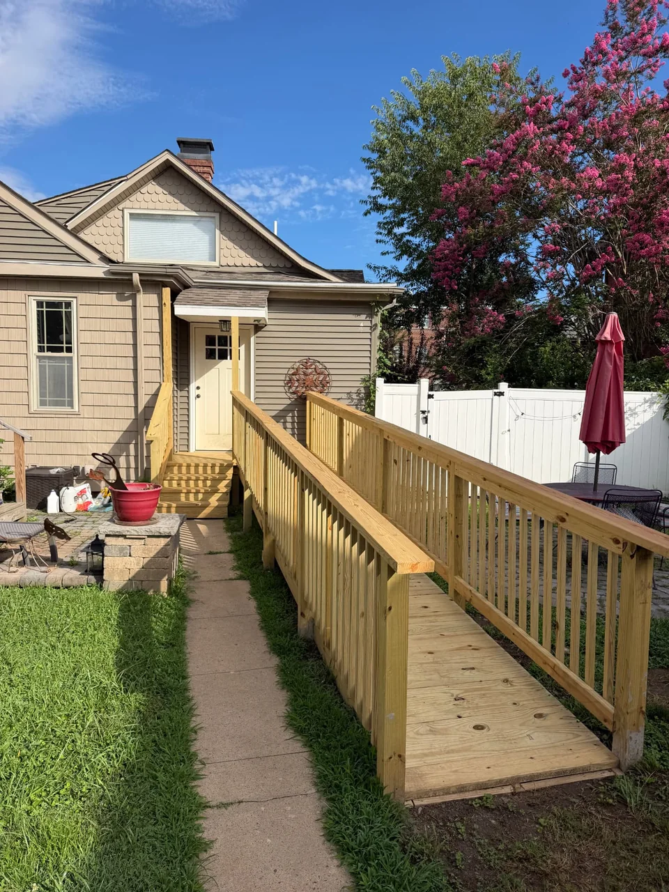 A wood entry ramp with matching railings.