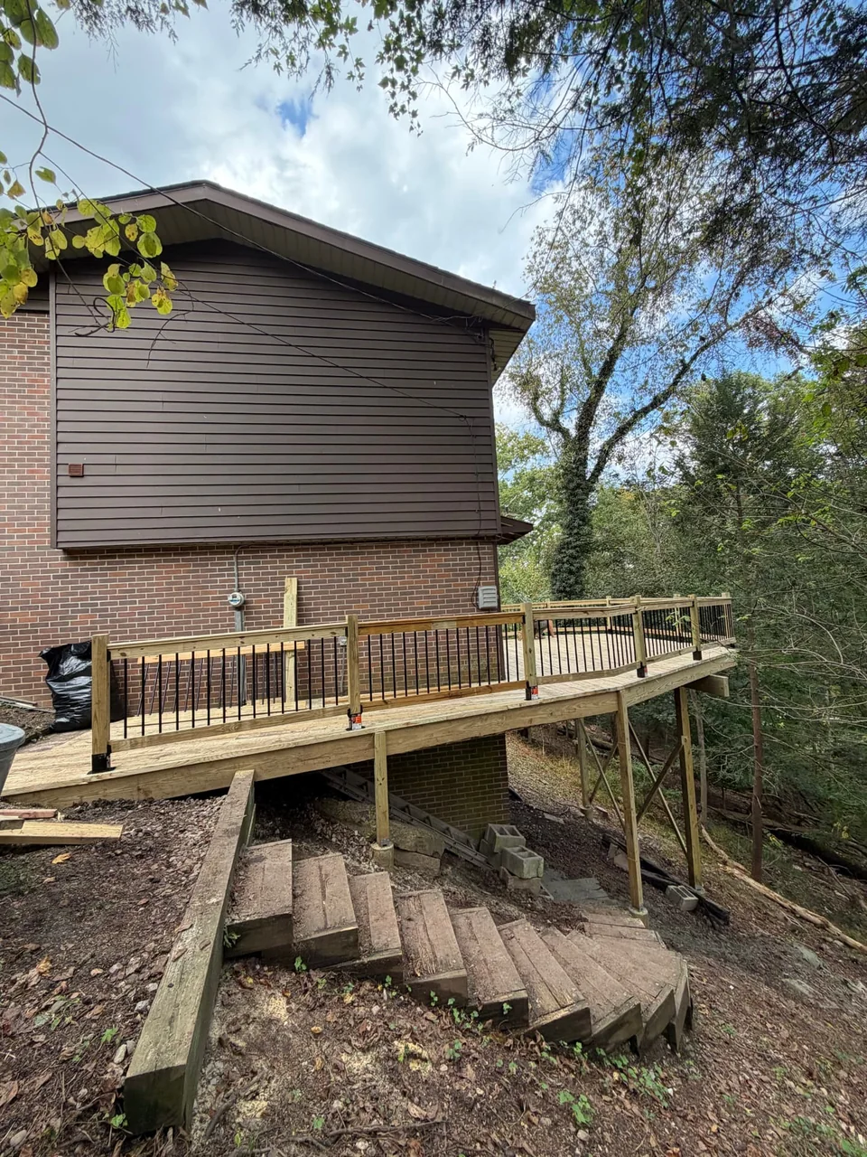 An elevated wood deck along the side of the home.